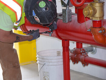 Northstar technician tightening a bolt on a fire protection system