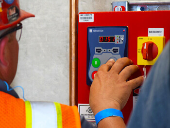 Man adjusting settings on a custom alarm and life safety system